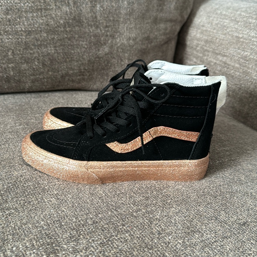 Black and gold Vans